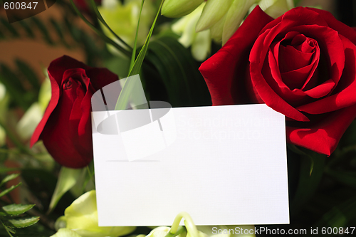 Image of Red roses, orchids and a blank card