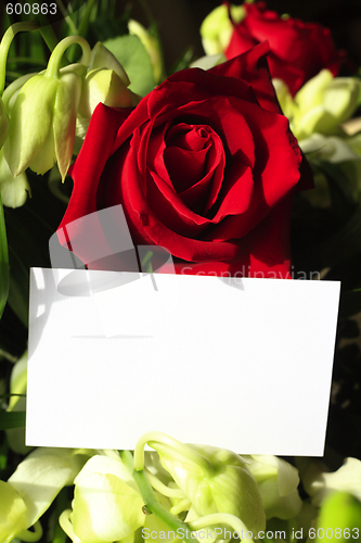 Image of Red roses, orchids and a blank card