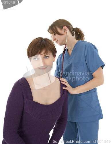 Image of Nurse listening to patient's heart with stethoscope