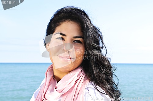 Image of Beautiful young woman at beach