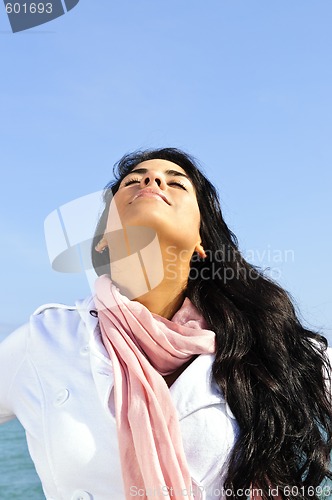 Image of Beautiful young woman at beach