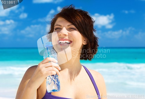 Image of happy woman with bottle of water