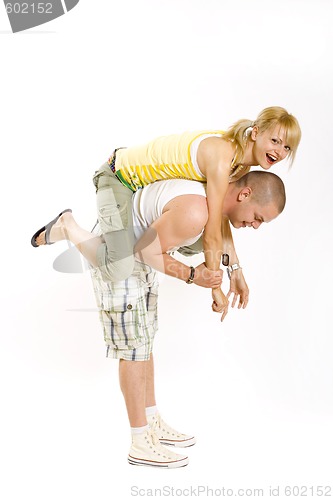 Image of young man holding his girlfriend in the air