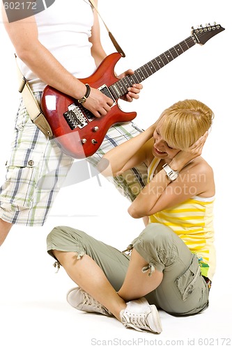 Image of passionate woman guitarist jumps in the air