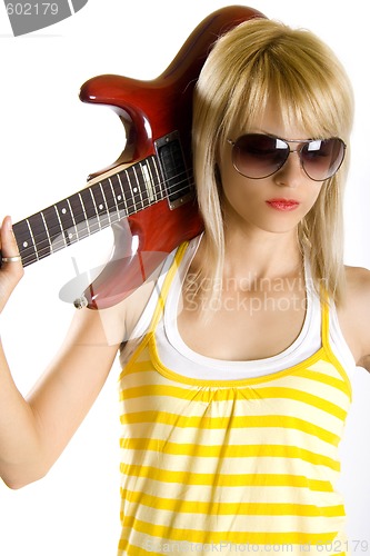 Image of portrait of an attractive woman guitarist making a rock sign