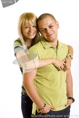 Image of young man holding his girlfriend in the air