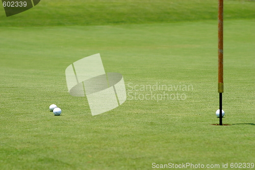 Image of Golf balls near flagstick