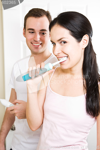 Image of Couple brushing teeth in the bathroom