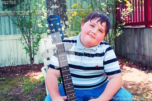 Image of Young boy with a guitar