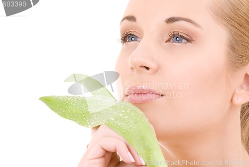 Image of woman with green leaf