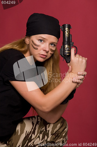 Image of beautiful girl with pistol