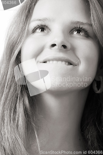 Image of beautiful girl bites lip