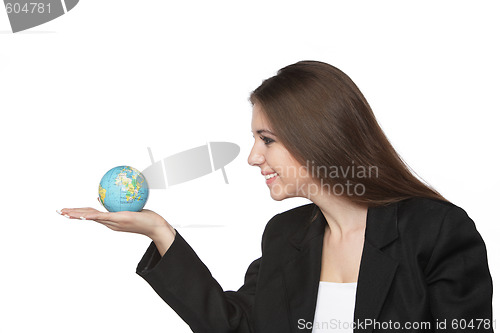 Image of Business woman looking at the earth in her hand
