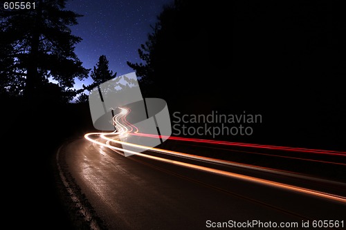 Image of Car Light Trails in the Mountains on a Starry Night
