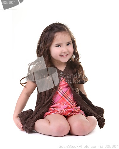 Image of Adorable Young Child Smiling and Sitting on Her Knees