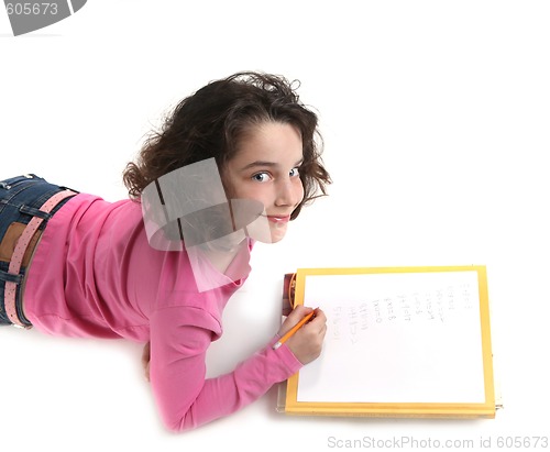 Image of Young Child Writing Her Homework on Paper