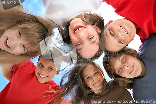 Image of Happy Kids Huddling and Looking Down