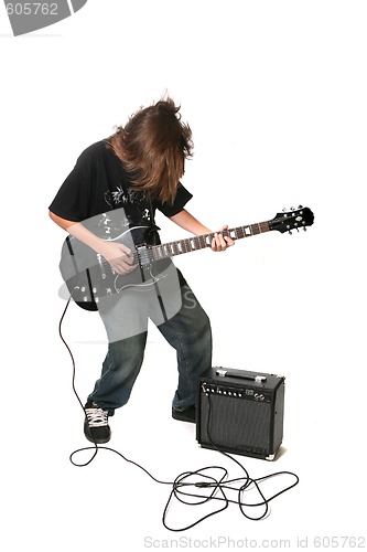 Image of Teenager Playing Electric Guitar With Amplifier