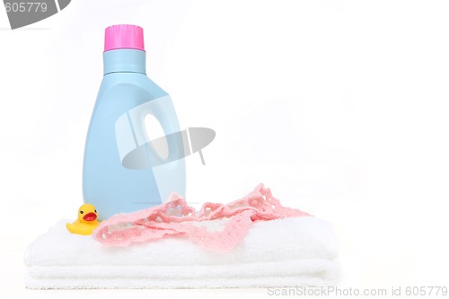 Image of Baby Girl Laundry Items With Bottle of Detergent