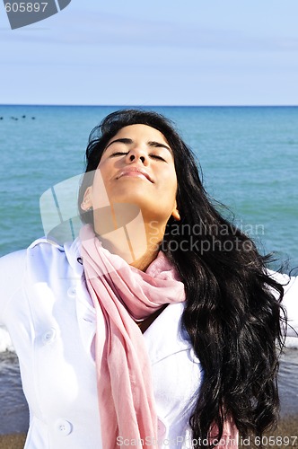 Image of Beautiful young woman at beach