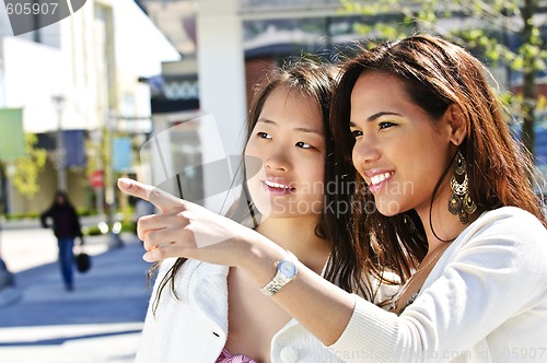 Image of Young friends pointing