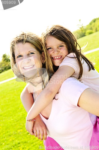 Image of Mother and daughter piggyback