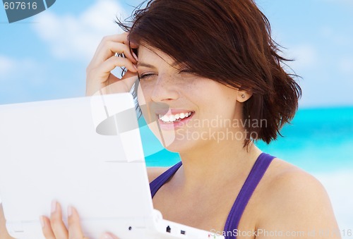 Image of woman with laptop computer on the beach