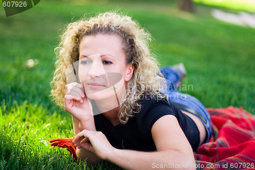 Image of woman lying on green grass