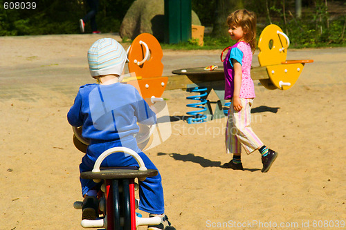 Image of The girl and the boy on sand