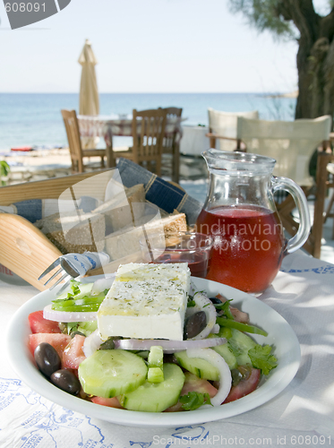 Image of home made rose wine with greek salad and crusty bread at greek i