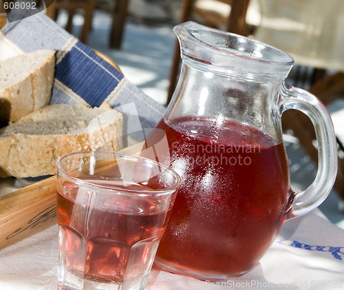 Image of home made rose wine and crusty bread at greek island taverna