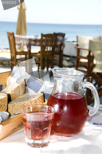 Image of home made rose wine and crusty bread at greek island taverna