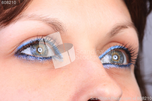 Image of beautiful woman`s open colorful eye