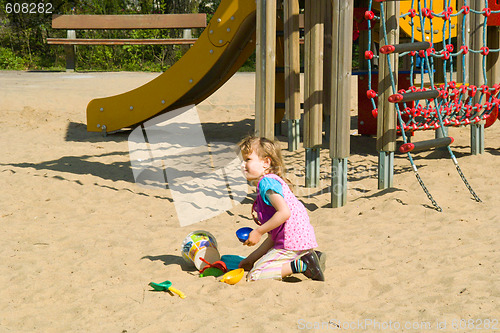 Image of The girl plays on the sands