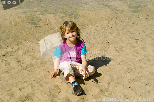 Image of The girl sits on sand