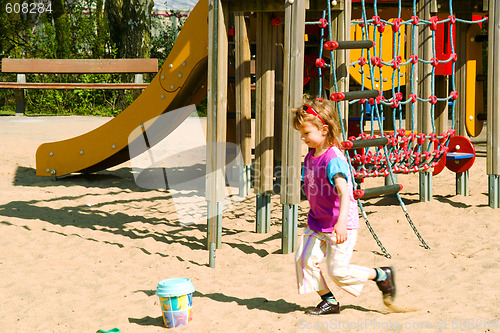 Image of The girl plays on the sands