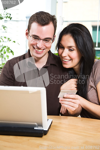 Image of Happy couple shopping online