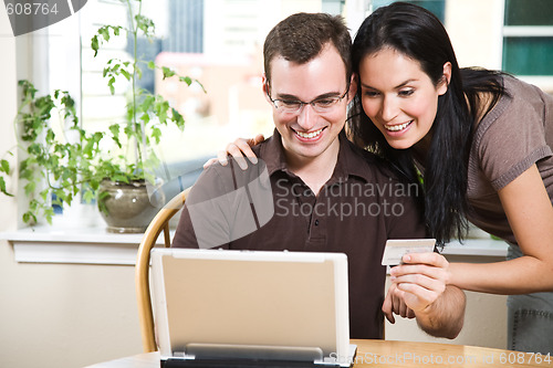 Image of Happy couple shopping online