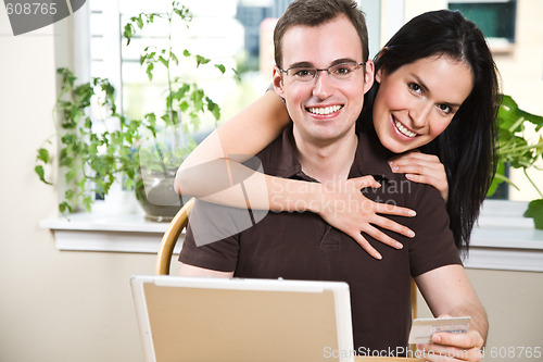 Image of Happy couple shopping online