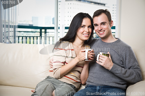 Image of Happy couple relaxing at home
