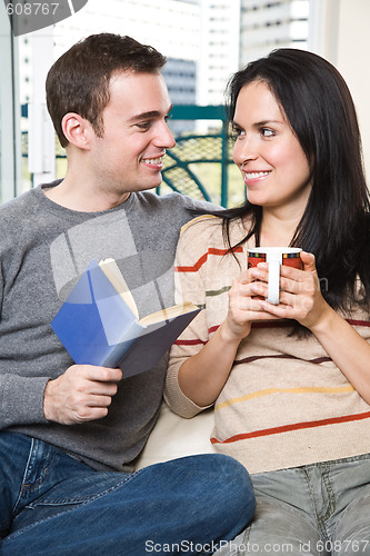 Image of Happy couple relaxing at home