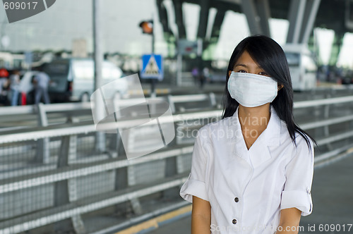 Image of protective face mask on asian woman