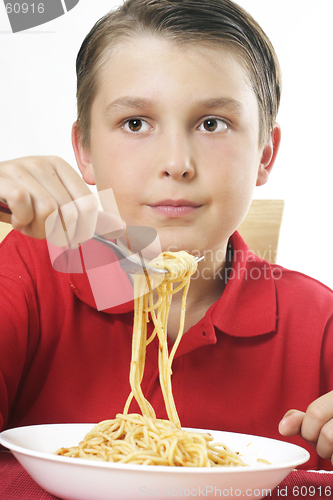 Image of Child with forkful of noodles