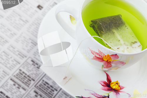 Image of Green tea with newspaper