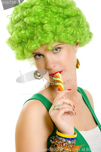 Image of closeup of an attractive woman liking a lolly pop