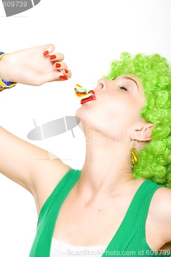 Image of closeup of an attractive woman liking a lolly pop