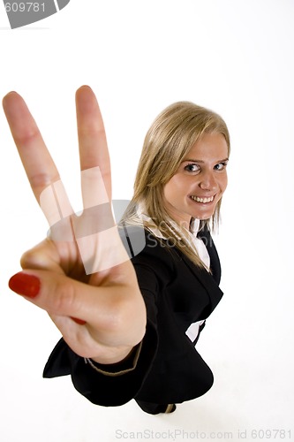 Image of wide angle picture of an attractive businesswoman making her victory sign