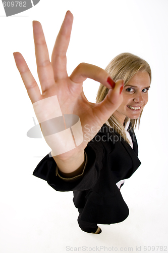 Image of wide angle picture of an attractive businesswoman making her victory sign