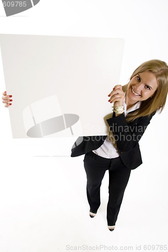 Image of wide angle picture of an attractive businesswoman presenting a blank board