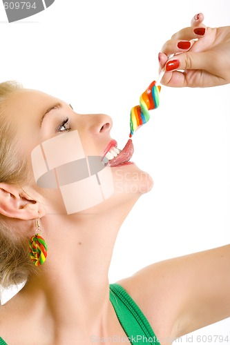 Image of closeup of an attractive woman liking a lolly pop